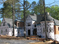 The roof is on and they are working on the cedar shingles.