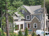 The stone veneer installation is complete and the exterior painting has started.